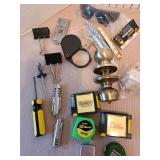 Calculators, doorknob, small levels, measuring tapes, magnifying glass, more