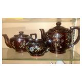 The image features a vintage trio of Japanese brown-glazed Moriage teapots.