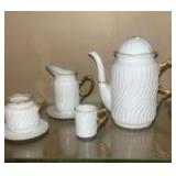 This is a Formalities by Baum Bros miniature white with gold trim tea set, made of bone china.