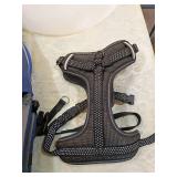 Dog lot including cone, sweater, and harnesses.