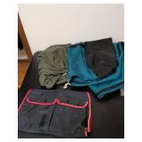 One large teal bag military duffel bag and another bag