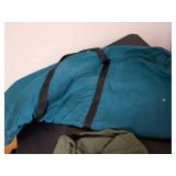 One large teal bag military duffel bag and another bag