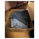 Stack of mens winter coats and jeans