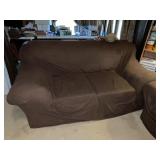 Brown covered love seat