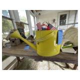 Watering can, rest of contents on table