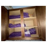 Purple towels in cabinet