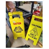 Two wet floor signs