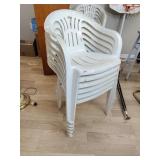 Six plastic white chairs