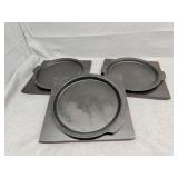 Three cast servers on wood