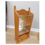 Small wood display, glass shelves is pictured