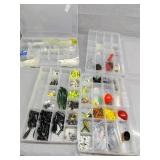 Four plastic containers all have fishing tackle
