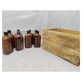 Brown glass bottles and  Western Wood ammo crate
