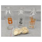 Three glass milk jugs of 18 bottle caps