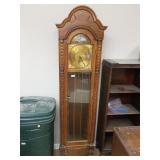 Colonial grandfather clock has three weights not