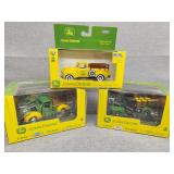 Three John Deere delivery truck displays