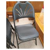 Six black folding chairs