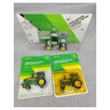 Three small John Deere tractors