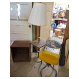 Roll around chair, table lamp and wood cabinet