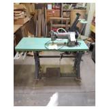 Consew sewing machine on table with castors