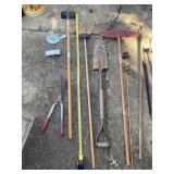 Rakes, hoe, broken spade, shears and solar lights