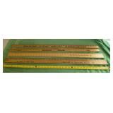 Yard sticks from various businesses
