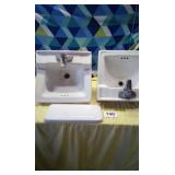 2 bathroom sinks and tank cover