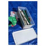 Plastic tote full of Christmas wrapping paper