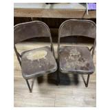 Two brown folding aluminum chairs