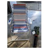 Foldup red white and blue lawn chair, green bag