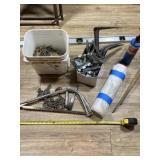 Level, small propane torch, roll of plastic and