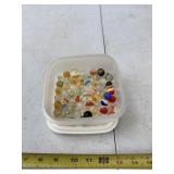 Plastic container of marbles with lid