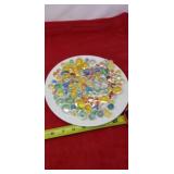 Plate full glass marbles and shooters