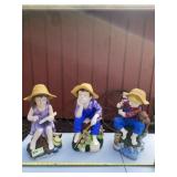 Resin boy and girl statues with chipping on them