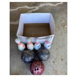 Three bowling bowls and four pins