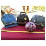 Four bowling balls, three with cases and two