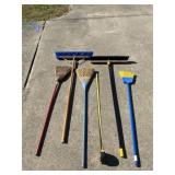 Two shop brooms and three smaller brooms