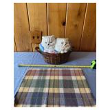 Ceramic cat filled with sewing supplies and table