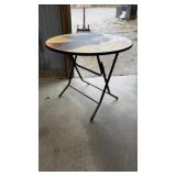 round folding table with a dog-themed top.
