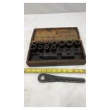 Antique socket wrench set housed in a wooden box.