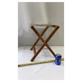 American folding camp stool with a striped canvas