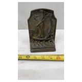cast iron bookend featuring a Nordic or Viking