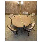 Round card table with four cushioned chairs