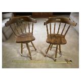 Two swivel barstools with foot rails, floor to