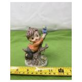 Hand painted bisque boy with bird figurine