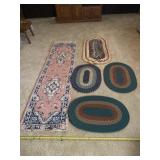 Pink runner rug with a tear on one end, four oval