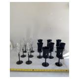 Tall stem wine glasses, one all black has a chip