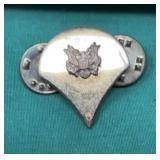 U.S. Army Specialist (E-4 pay grade) rank pin.