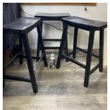 Three wood stools measure 24 inches from floor to
