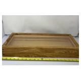 Wood and plastic showcase measures 21 inches x 9