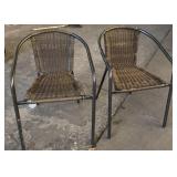 Two plastic wicker patio chairs
